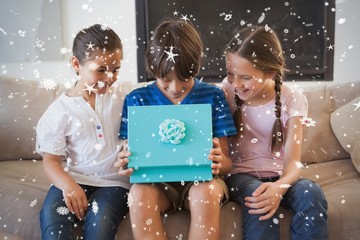 Composite image of happy young kids with gift box