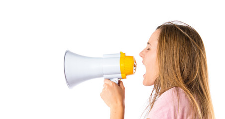 Blonde girl shouting with a megaphone over white background