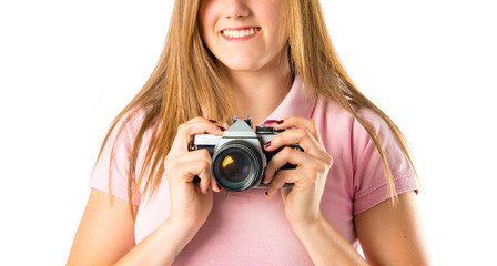 Girl taking a picture over white background