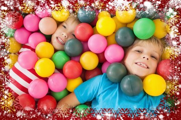 Fototapeta na wymiar Composite image of happy children playing in ball pool