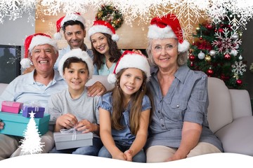 Extended family in christmas hats with gift boxes