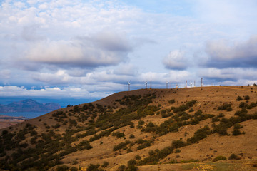windmills on the mountain near the sea harbor