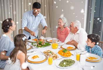 Composite image of extended family at dining table in house