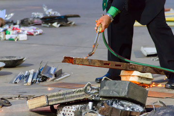 A worker uses a oxygen acetylene cutting