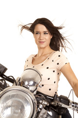 Fototapeta na wymiar woman close on motorcycle hair blowing look side