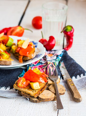 vegetarian appetizer fried bread with vegetables on wood