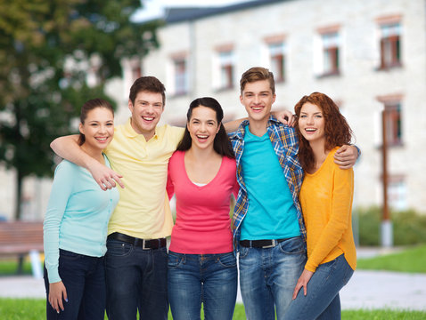 group of smiling teenagers over campus background