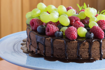 Chocolate cake with fresh berries and grape, selective focus