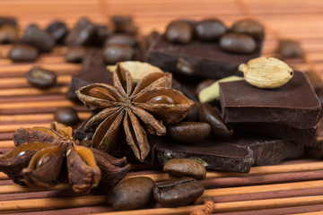Close up of  anise, cardamom with chocolate and coffee heap