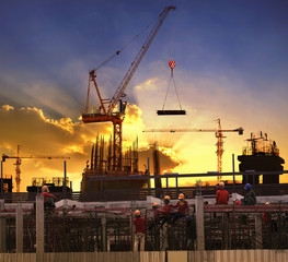 worker working in high building construction site against beauti