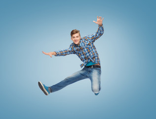 smiling young man jumping in air