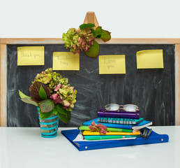 Love you teacher. Hydrangea flowers and copybooks on the teacher