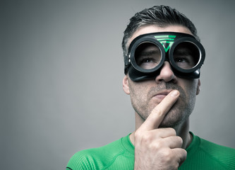 Pensive superhero with hand on chin