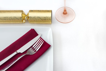 Christmas place setting with gold cracker