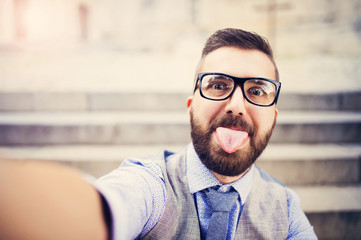 Hipster businessman taking selfie