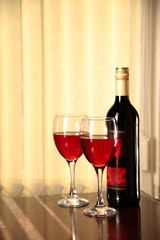 Red wine in glasses and bottle.