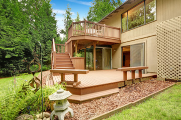 Wooden walkout deck with patio and benches
