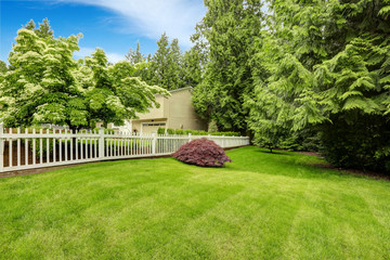 Beautiful front yard landscape with white fence