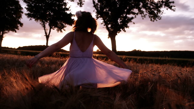 Woman Twirling in Wheat Field