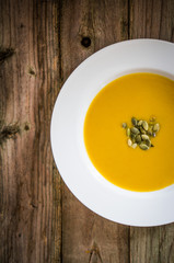 Pumpkin soup on wooden background