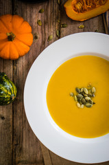 Pumpkin soup on wooden background