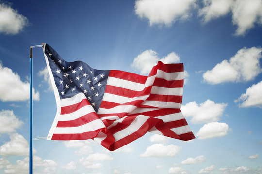 American flag flying in blue sky
