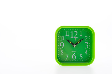 Green clock isolated on white background