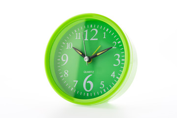 Green clock isolated on white background