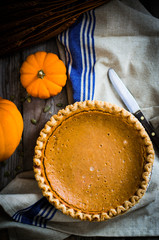 Pumpkin pie on rustic background