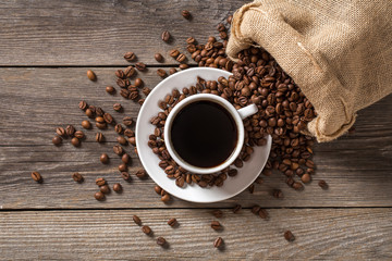 Coffee cup with coffee bag on wooden table. View from top. 