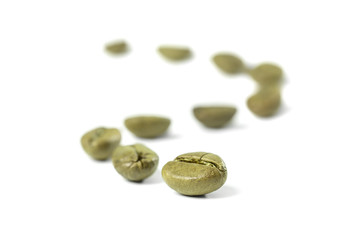Green coffee beans draw a zigzag line. Isolated on white 