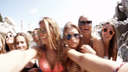Group of girl friends taking selfie at the beach - Powered by Adobe