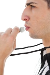 Side view of referee blowing whistle