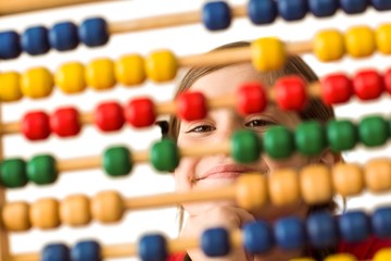 Cute little girl using an abacus