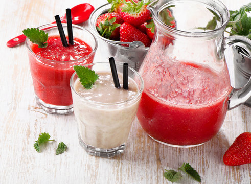 Strawberry smoothie with  berries on a wooden background