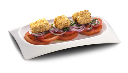fried chicken fillet with sesame on a slice of tomato and onion
