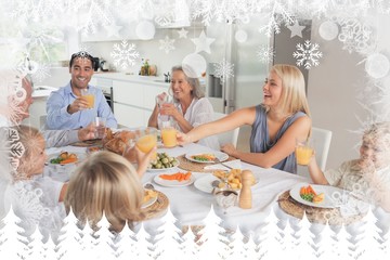 Composite image of family raising their glasses together