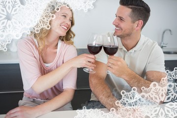 Composite image of couple toasting red wine glasses at table