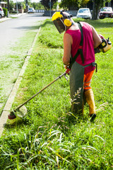 Man cutting grass with petrol mower