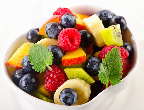 Healthy fruit salad in a white bowl