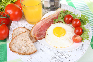 Scrambled eggs with bacon and vegetables served