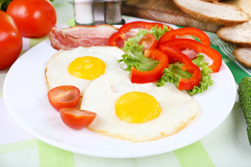 Scrambled eggs with bacon and vegetables served