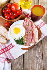 Scrambled eggs with bacon and vegetables served