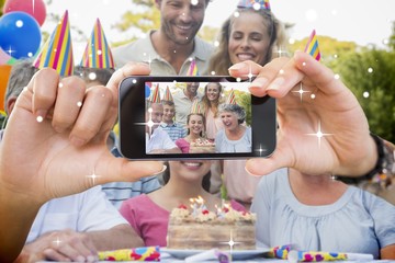 Hand holding smartphone showing photo