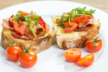 Fresh Bruschetta Sandwich With Bacon, Rucola And Tomatoes