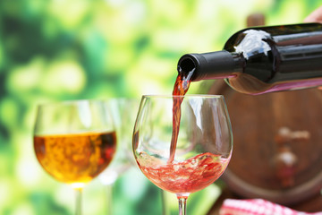 Red wine pouring into wine glass, close-up