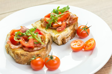 Fresh Bruschetta Sandwich With Bacon, Rucola And Tomatoes