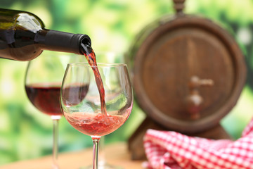 Red wine pouring into wine glass, close-up