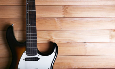 Fototapeta na wymiar Guitar on wooden background