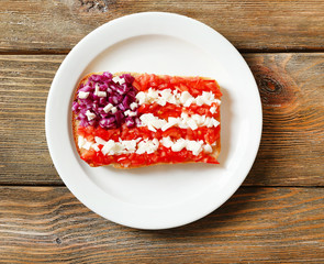 Sandwich with flag of USA on table close-up